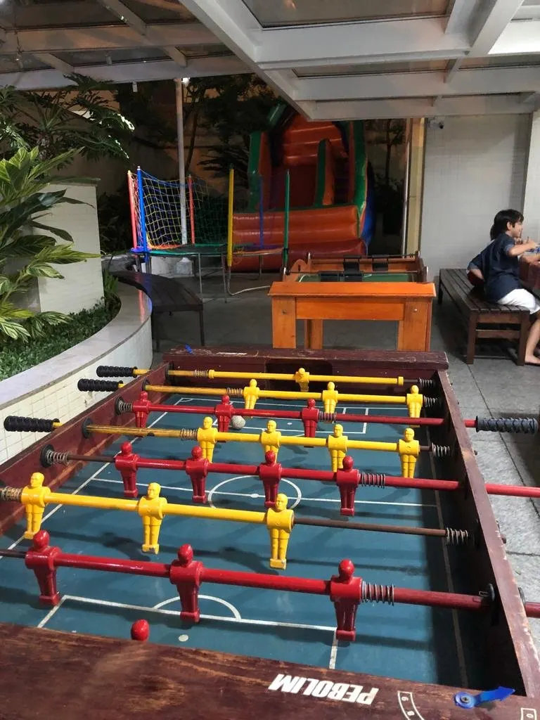 Mesa de totó (pebolim) em uso durante festa com jogadores